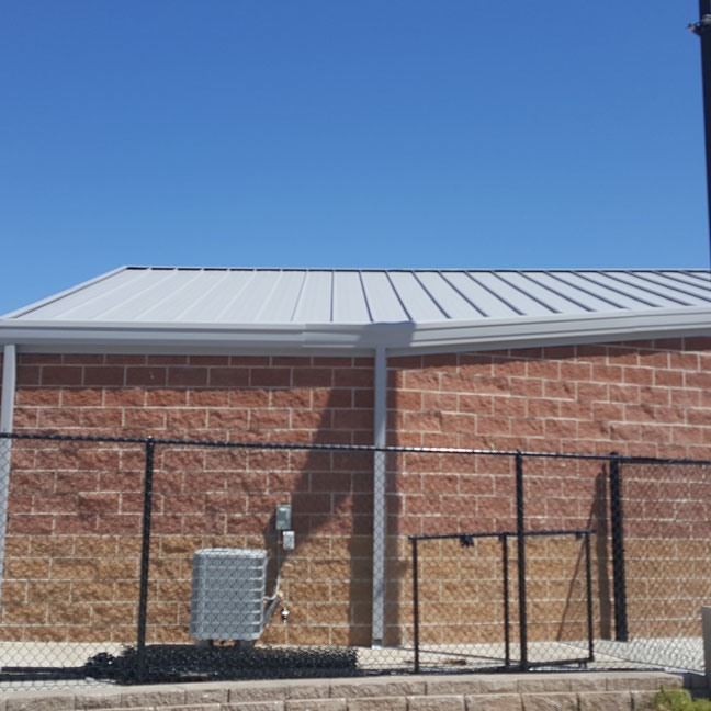 New standing seam metal roof system with sub framing attached to a CMU block structure.